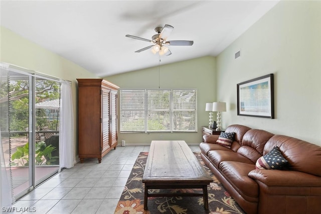 tiled living room featuring ceiling fan and vaulted ceiling