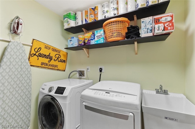 laundry area with washer and clothes dryer and sink