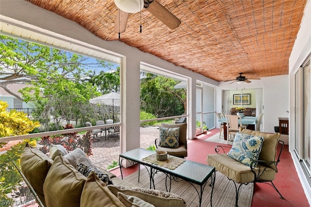 sunroom / solarium featuring brick ceiling and ceiling fan