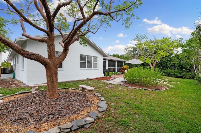 exterior space featuring a yard, a sunroom, and central AC