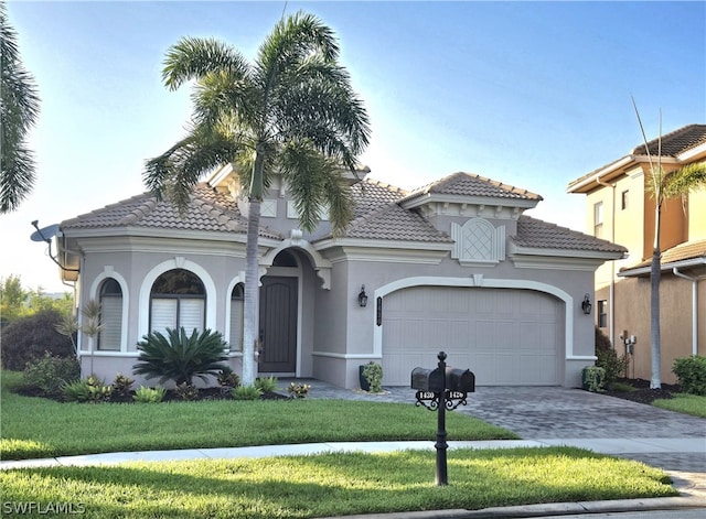 mediterranean / spanish house with a garage and a front lawn