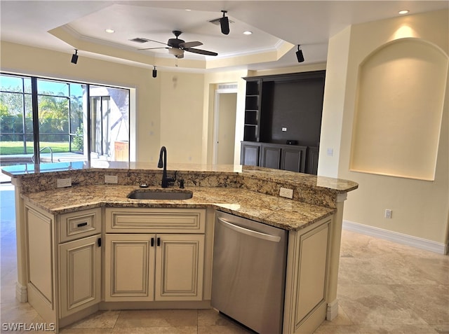 kitchen featuring cream cabinets, dishwasher, ceiling fan, a raised ceiling, and sink