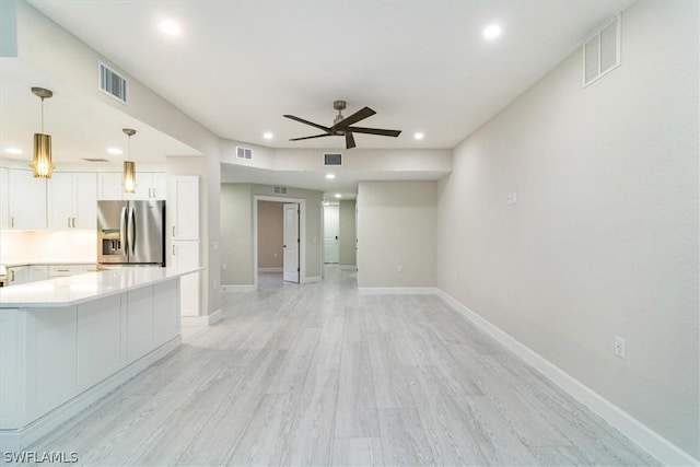 unfurnished living room with ceiling fan and light hardwood / wood-style floors