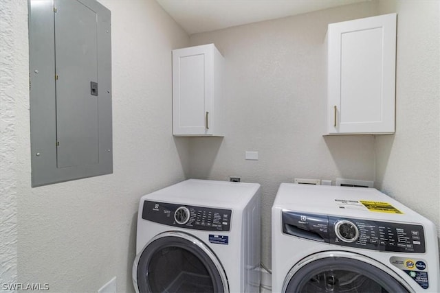 washroom featuring cabinets, electric panel, and independent washer and dryer