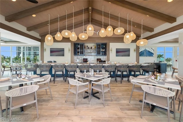 dining space with wood ceiling, beamed ceiling, a healthy amount of sunlight, and high vaulted ceiling