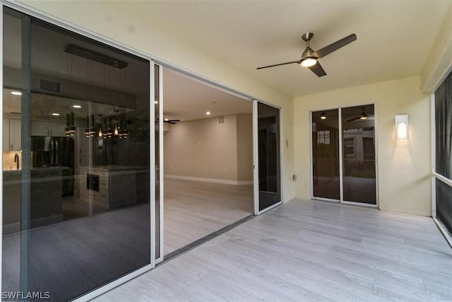 exterior space with ceiling fan