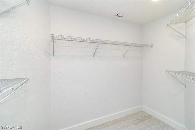 spacious closet with wood-type flooring