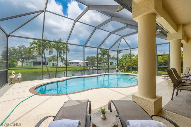 view of swimming pool featuring glass enclosure and a patio area