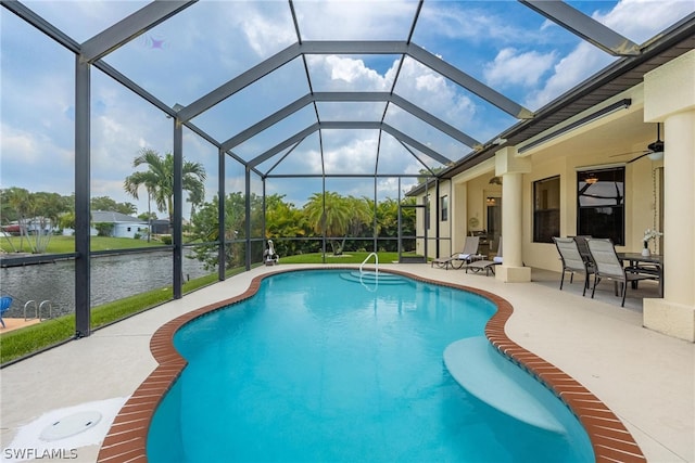 view of pool featuring a patio area, a lanai, a water view, and ceiling fan