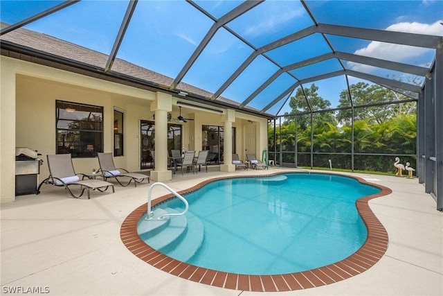 view of swimming pool featuring a lanai, a patio area, and ceiling fan