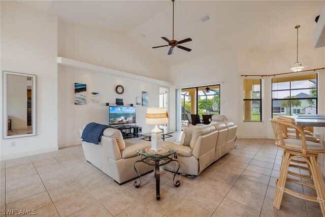 tiled living room featuring high vaulted ceiling and ceiling fan