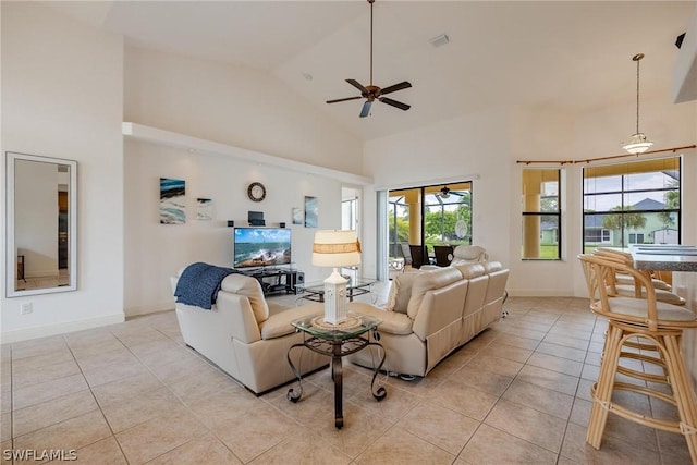 living room featuring ceiling fan, high vaulted ceiling, and light tile patterned floors