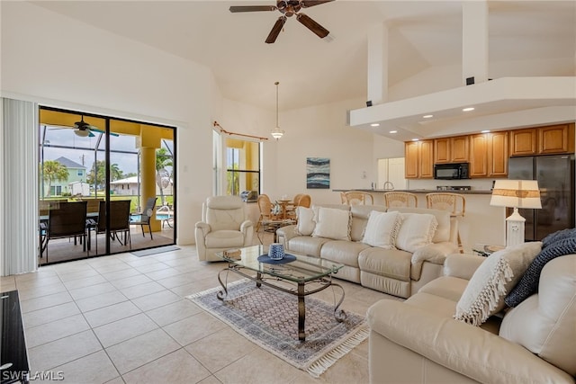 living room with high vaulted ceiling, ceiling fan, and light tile flooring