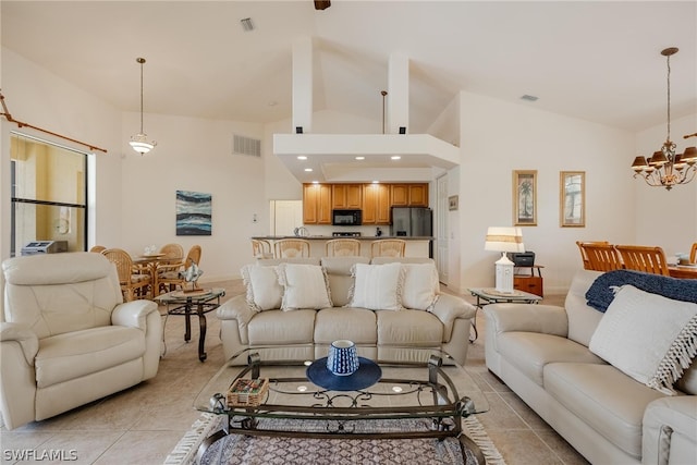 living room featuring high vaulted ceiling, a chandelier, and light tile floors