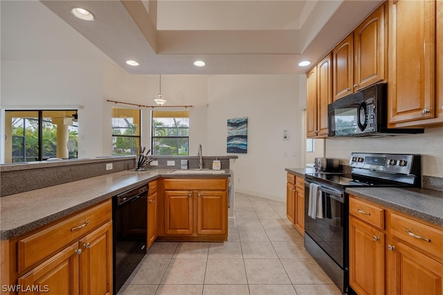 kitchen featuring decorative light fixtures, black appliances, a raised ceiling, light tile floors, and sink