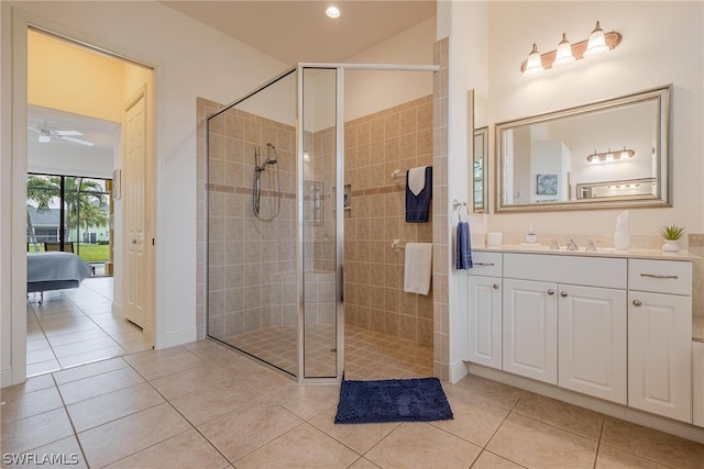 bathroom with tile floors, ceiling fan, an enclosed shower, and vanity