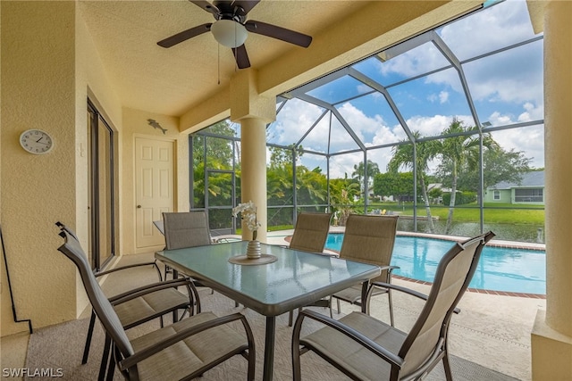 sunroom featuring ceiling fan