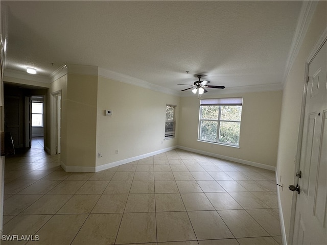 tiled empty room featuring ceiling fan, a healthy amount of sunlight, a textured ceiling, and crown molding