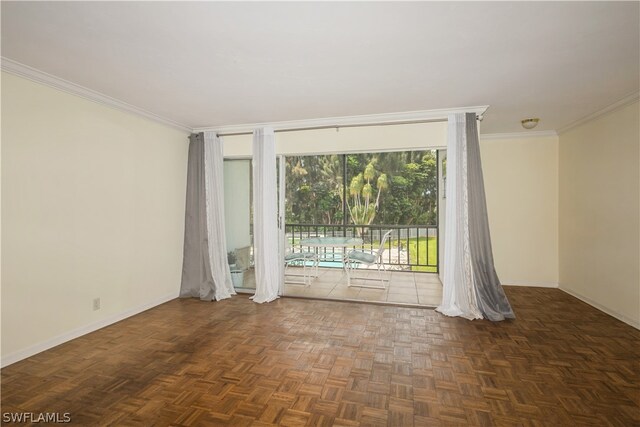 empty room featuring dark parquet flooring and crown molding