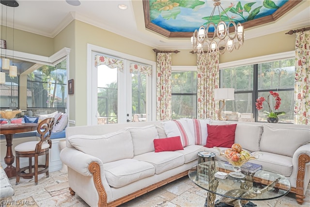 tiled living room featuring a tray ceiling, ornamental molding, a healthy amount of sunlight, and french doors