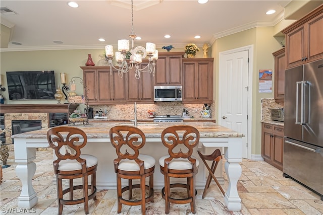 kitchen featuring a fireplace, stainless steel appliances, a kitchen island with sink, tasteful backsplash, and light tile floors