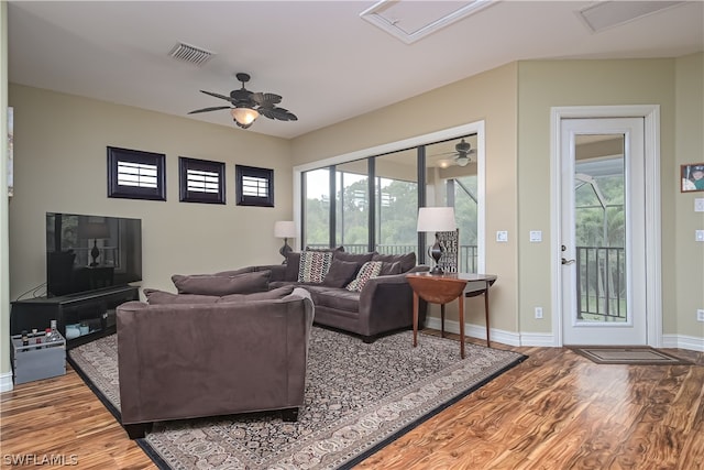 living room with ceiling fan and wood-type flooring