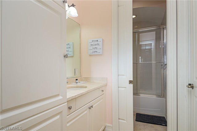 bathroom with bath / shower combo with glass door and vanity