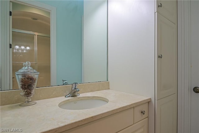bathroom with vanity and a shower with shower door