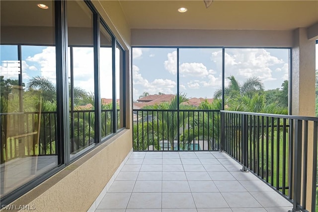 unfurnished sunroom featuring tile patterned flooring and recessed lighting
