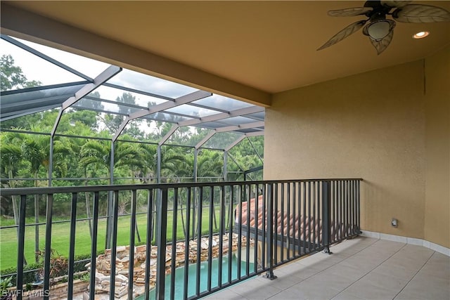 balcony featuring a ceiling fan, a patio, and a sunroom