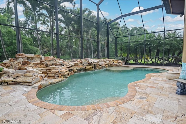 outdoor pool with glass enclosure and a patio