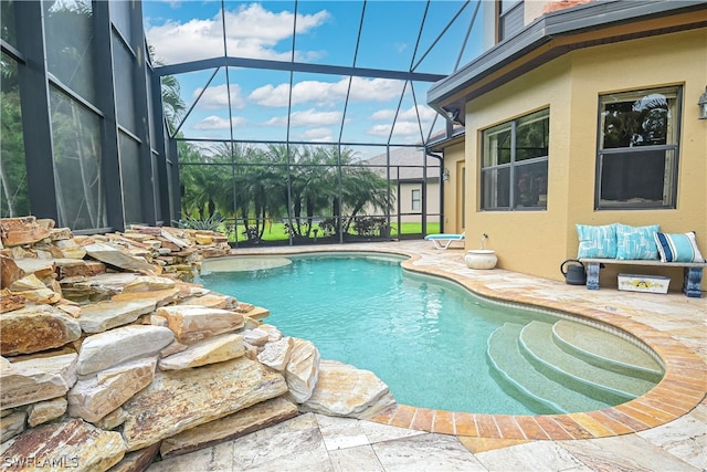 view of pool with a lanai and a patio area