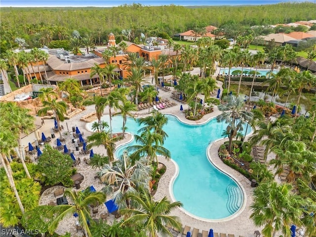 community pool with a wooded view