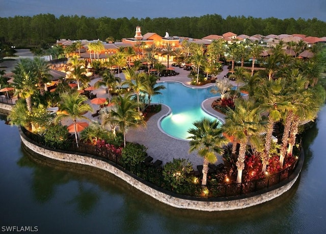 pool featuring a wooded view and a water view