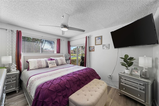 bedroom featuring ceiling fan, dark wood-type flooring, and a textured ceiling