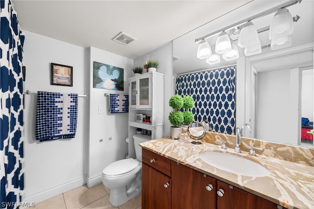 bathroom with tile patterned flooring, toilet, and vanity