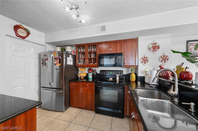 kitchen with black appliances, rail lighting, sink, a textured ceiling, and light tile patterned floors