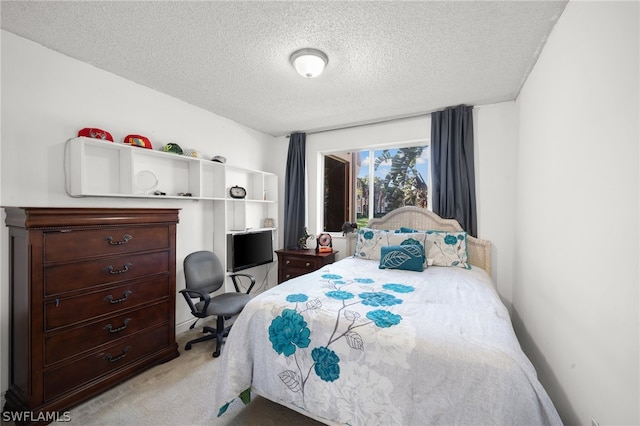 carpeted bedroom with a textured ceiling