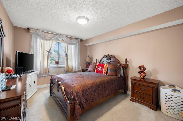 carpeted bedroom featuring a textured ceiling