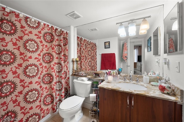 bathroom with tile patterned floors, toilet, and vanity