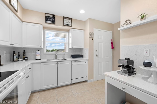 kitchen featuring sink, dishwasher, and white cabinets