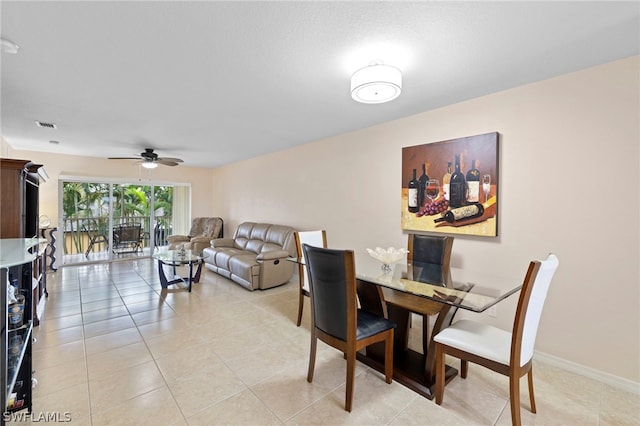 tiled dining area with ceiling fan