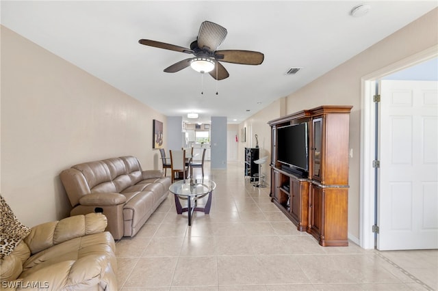 living room featuring ceiling fan and light tile floors