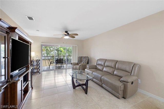 tiled living room with ceiling fan