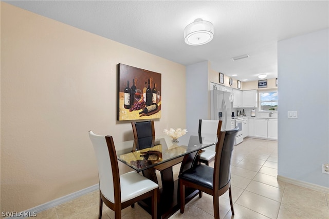 dining space with light tile floors