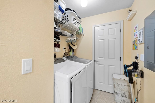 washroom with washing machine and clothes dryer, electric dryer hookup, and light tile floors