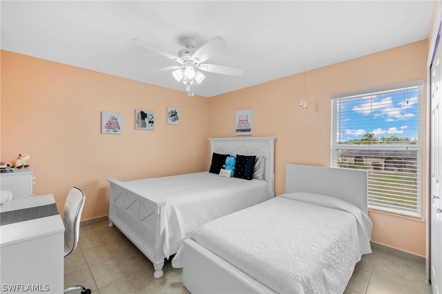 tiled bedroom with ceiling fan