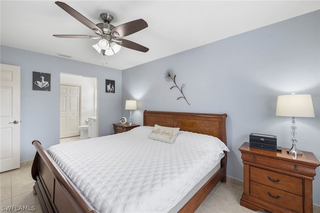 bedroom with ceiling fan, ensuite bath, and light tile floors