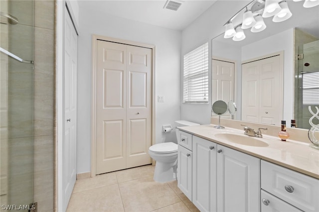 bathroom with tile flooring, vanity, and toilet