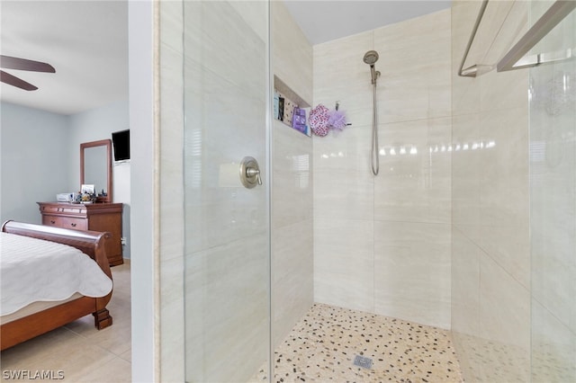 bathroom with a tile shower, tile flooring, and ceiling fan